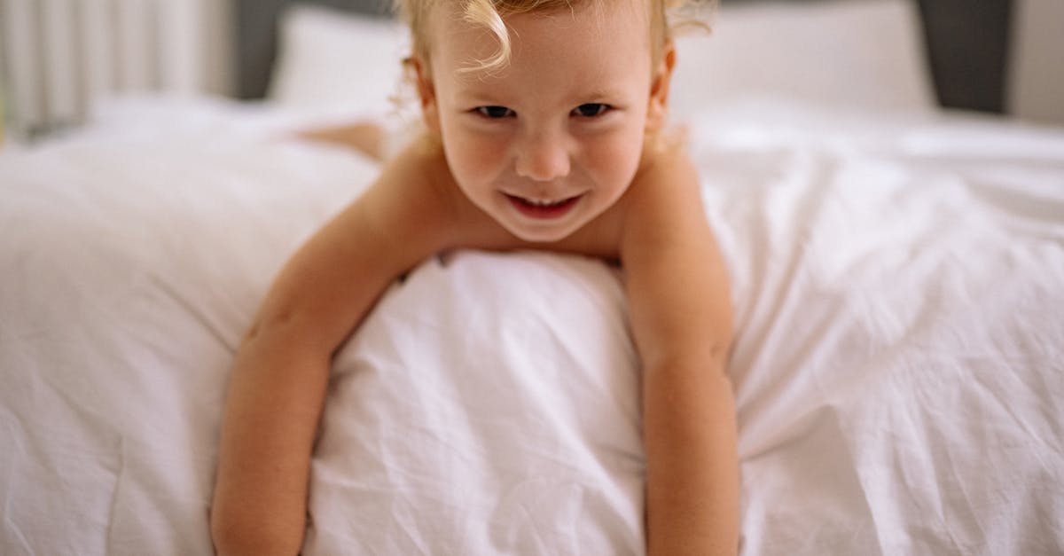 Time to deliver a baby [duplicate] - Topless Baby Lying on Bed