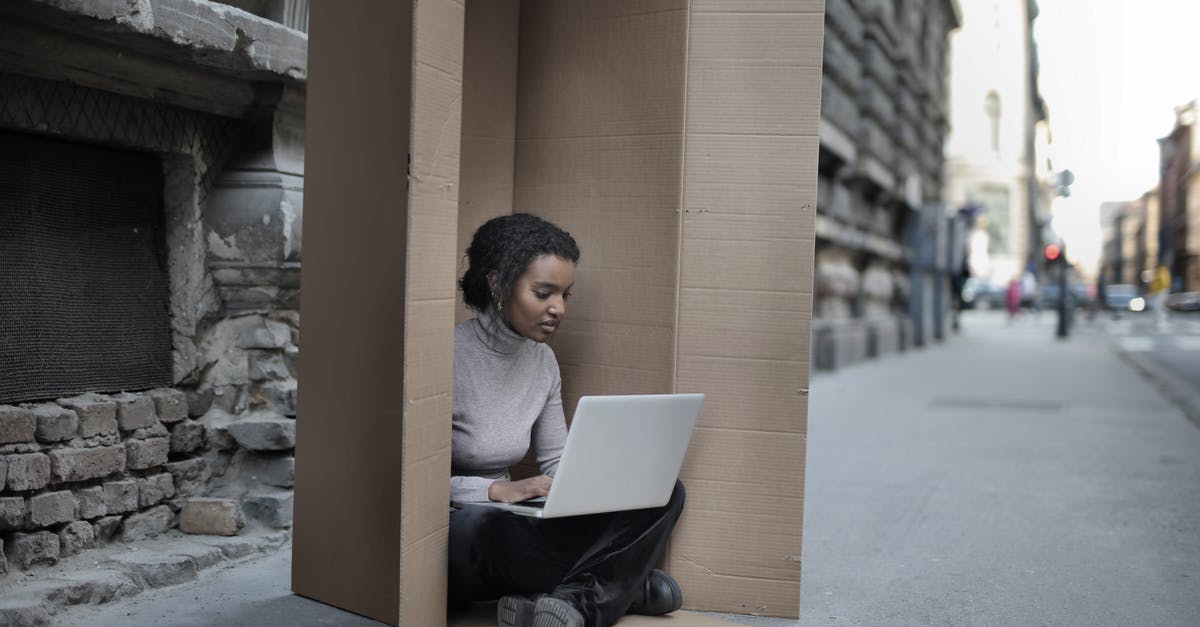 Transferring locally built Minecraft world to a remote server? [duplicate] - Young female introvert in casual clothes typing on netbook while sitting with crossed legs inside cardboard box located on asphalt road in city in afternoon