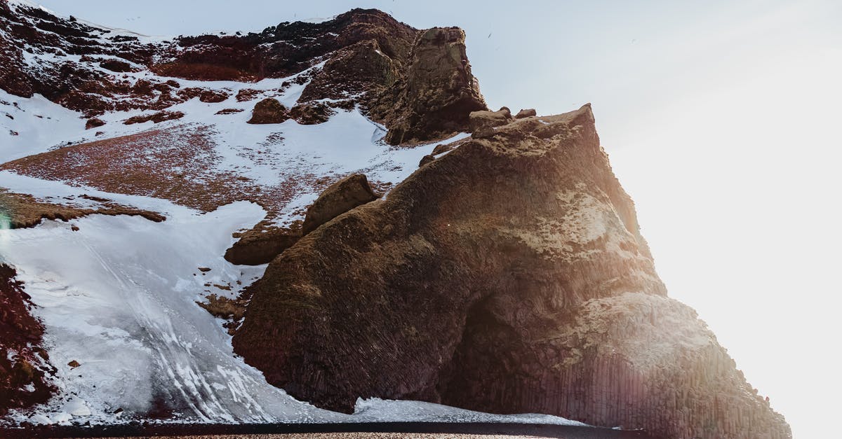 Transferring locally built Minecraft world to a remote server? [duplicate] - Light blue cloudless sky over high brown mountain slope covered with snow in sunlight