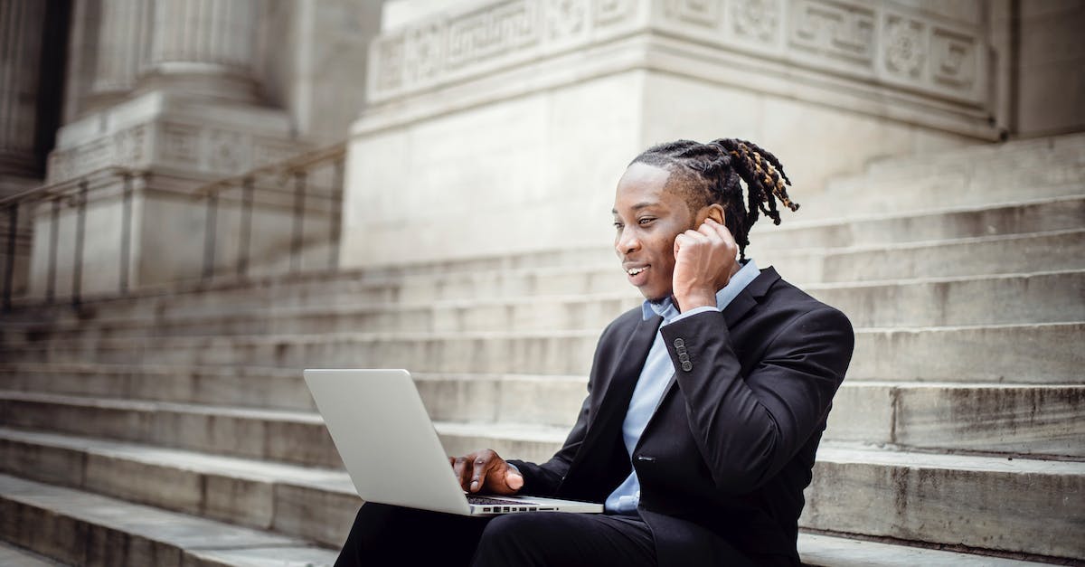 Tricks for using the rune stones? - Happy black businessman having video call on stairs