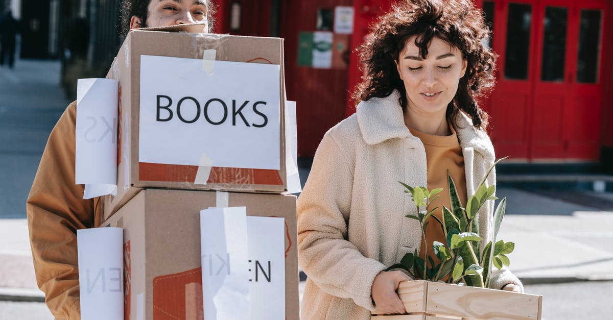 Troops walking out on me - A Couple Carrying Boxes And Plants Troops walking out on me - A Couple Carrying Boxes And Plants