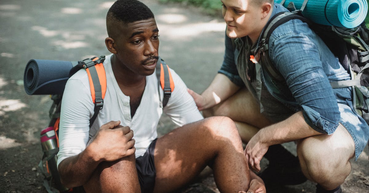 Trouble with Guard Break - Black man resting on ground during hike with friend