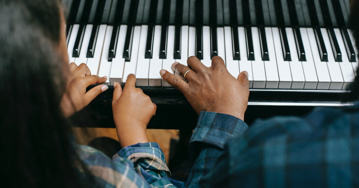 Turn 2nd player from a bubble to a girl - From above of crop anonymous African American man playing musical instrument with girl while rehearsing together