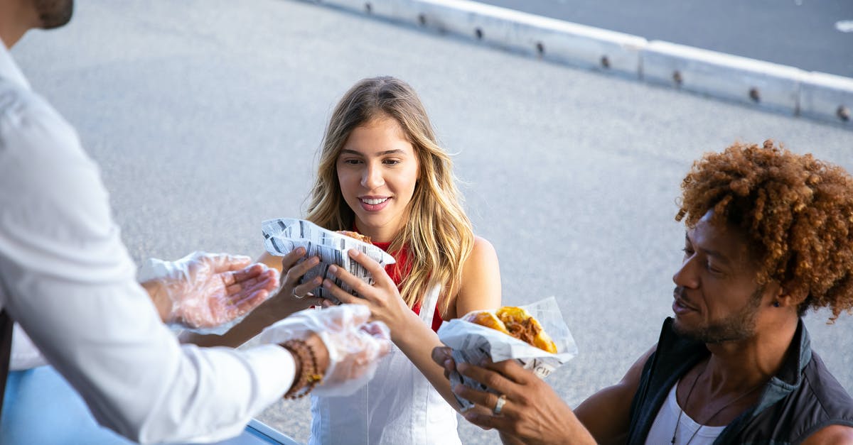 Unable to give player custom splash potion - High angle of positive multiracial couple getting delicious burgers from salesman working in food truck