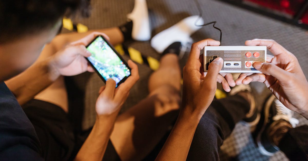 Unable to join online games of Among Us due to Parental Controls that were never set up? - Close-Up View of Two People Playing a Video Game