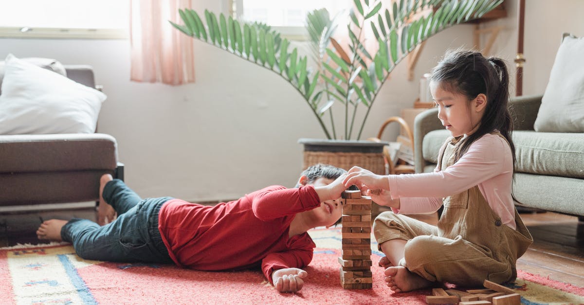 Unable to see created game in AoE2 in Windows 7 - Adorable Asian kids building wooden tower on floor at home