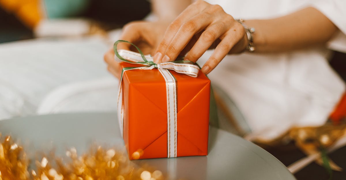 Unable to unwrap present - Person Holding Red Gift Box