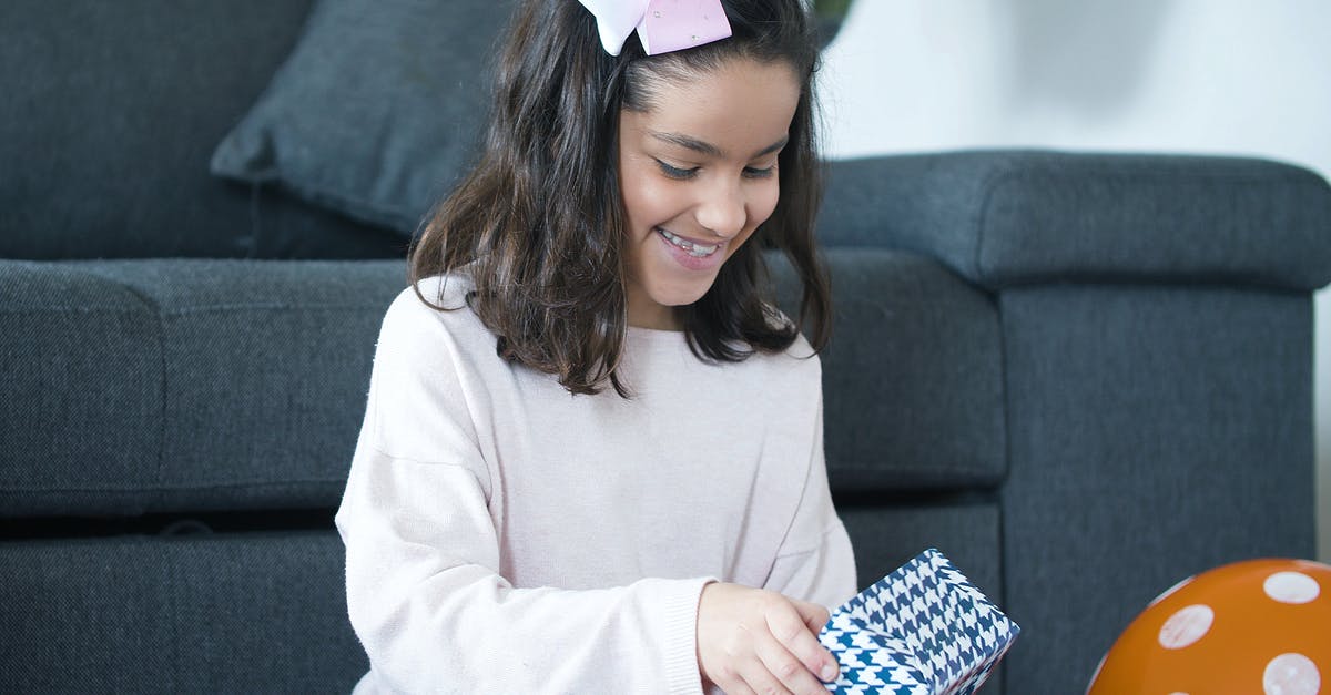 Unable to unwrap present - A Girl unwrapping a Gift
