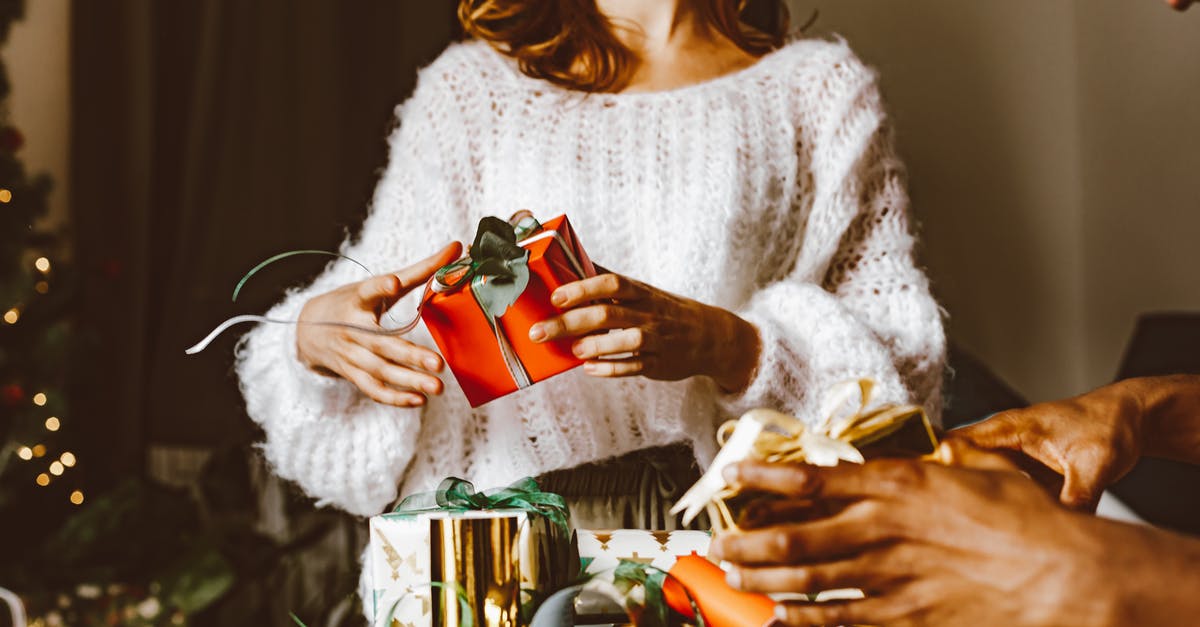 Unable to unwrap present - Woman in White Knit Sweater Holding Red and White Ceramic Mug