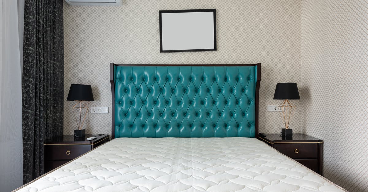 Under what conditions will healers switch targets? - Contemporary bedroom interior with bed under empty panel at home