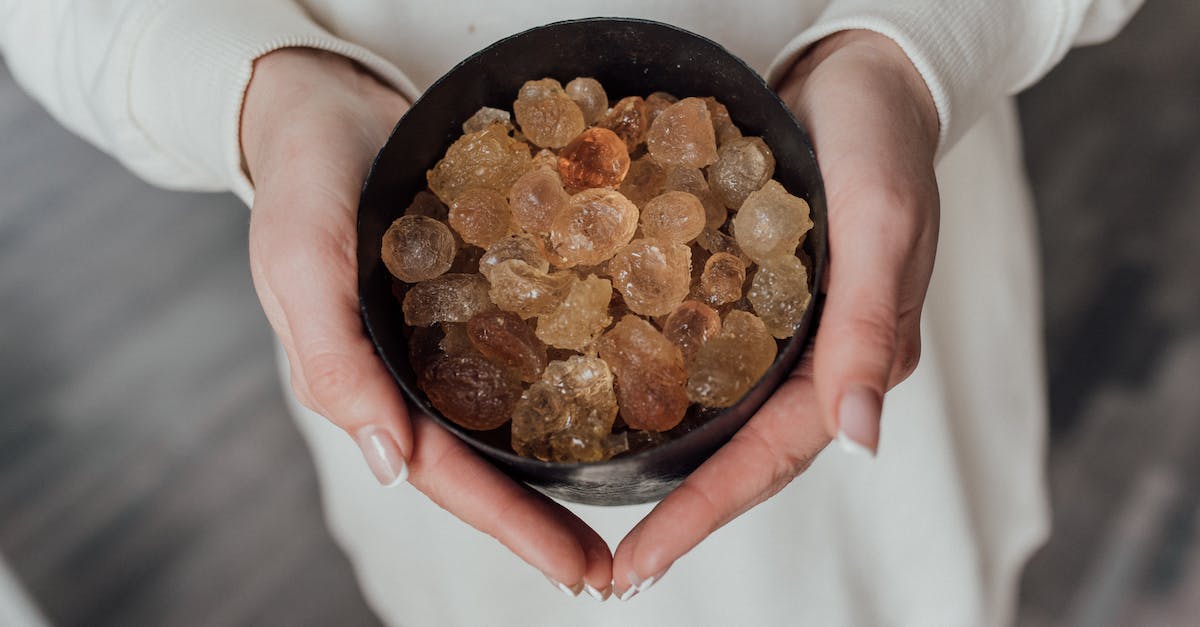 Unepic: Where i can find the first healing tome? - A Person Holding a Bowl of Crystals
