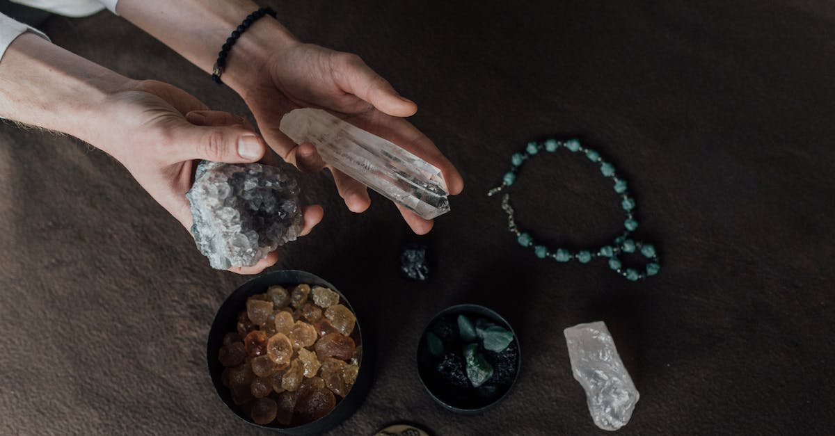 Unepic: Where i can find the first healing tome? - Person Holding White and Brown Stone