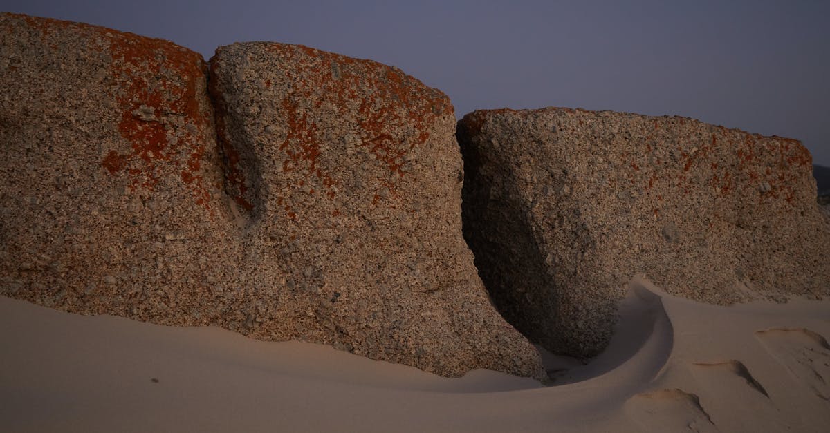 Unknown quest area in desert - Stones in sandy terrain in evening