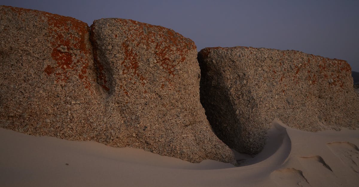 Unknown quest area in desert - Stones in sandy terrain in evening Unknown quest area in desert - Stones in sandy terrain in evening
