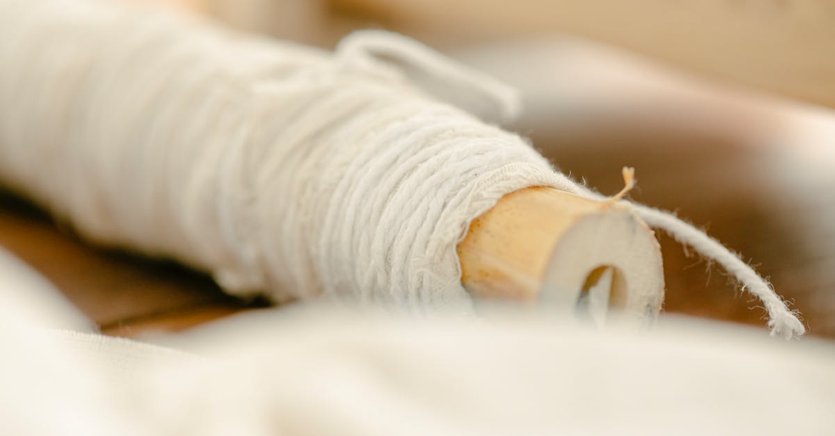 Unknown USB stick included with new PS3 controller? - Thread reeled on wooden stick placed on wooden table on blurred background in light room Unknown USB stick included with new PS3 controller? - Thread reeled on wooden stick placed on wooden table on blurred background in light room