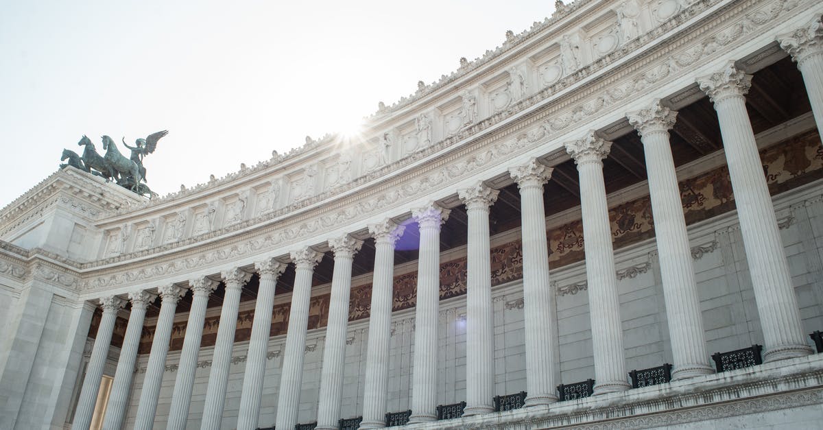 Unloading horse from a minecart! - From below of majestic columns of Altare della Patria in Rome on sunny day Unloading horse from a minecart! - From below of majestic columns of Altare della Patria in Rome on sunny day