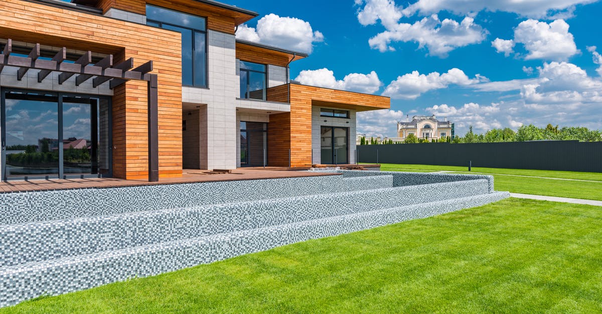 Unnatural silence in New Pokemon Snap - Exterior of contemporary residential house with panoramic windows glass doors and green lawn in yard on sunny day against blue sky with white clouds