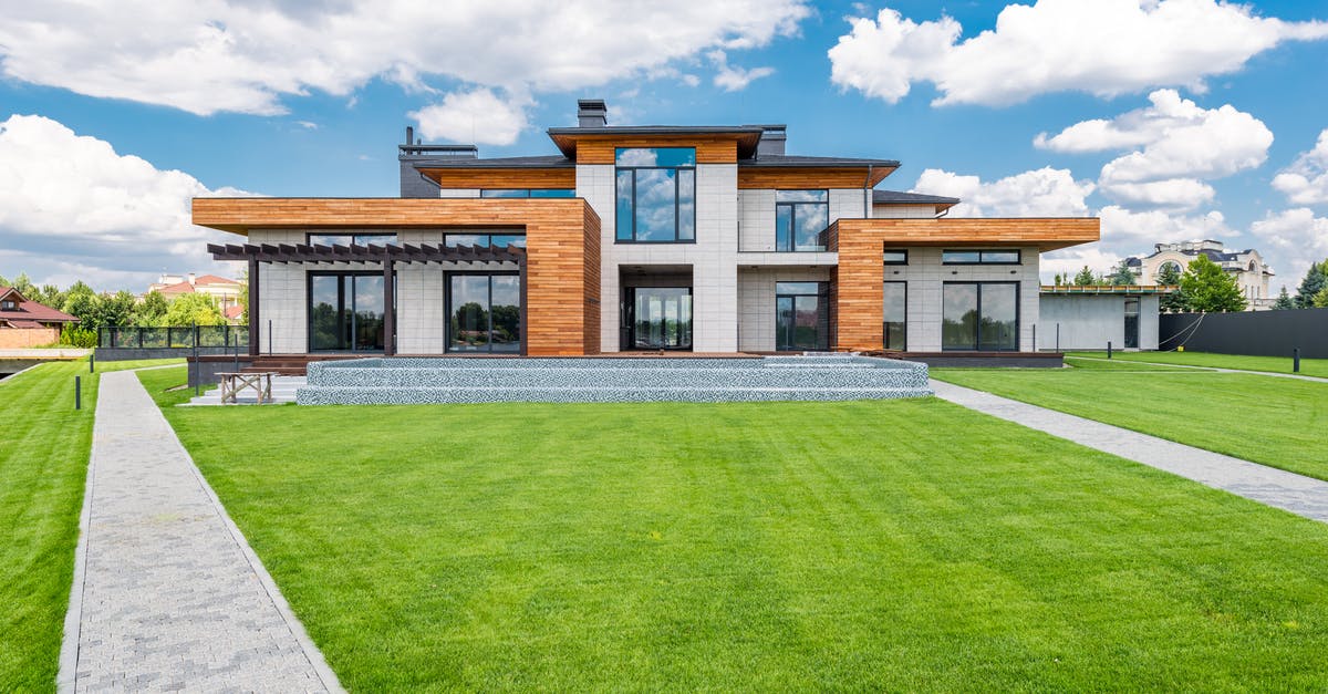 Upgrading vs building new items - Exterior of modern house with glass doors and panoramic windows