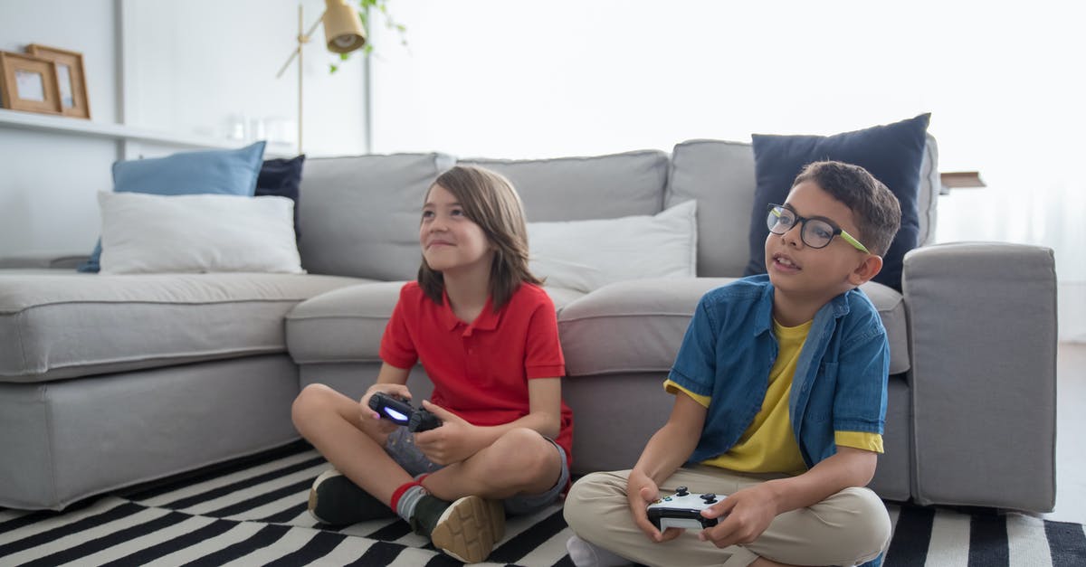 Use Taiko drum for random games - Two Young Boys Sitting on Striped Rug