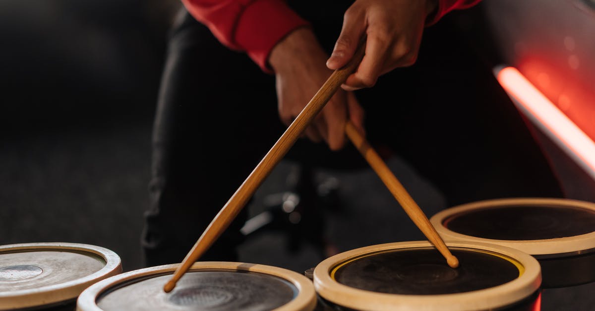 Use Taiko drum for random games - Person Holding Brown Wooden Drumsticks