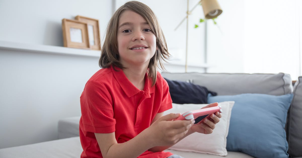 Use Taiko drum for random games - Boy Wearing Red Shirt Sitting on the Sofa