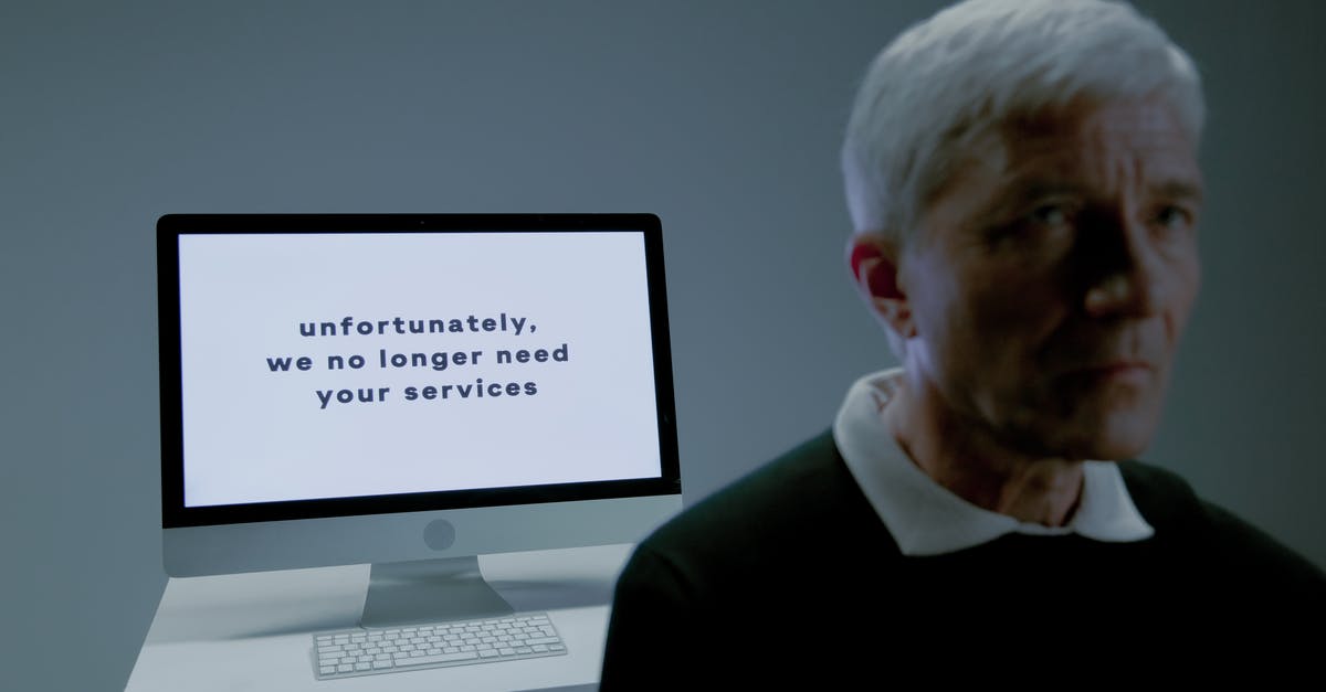 Useless upgrades? - Elderly man and screen with information that his services are no longer needed Useless upgrades? - Elderly man and screen with information that his services are no longer needed