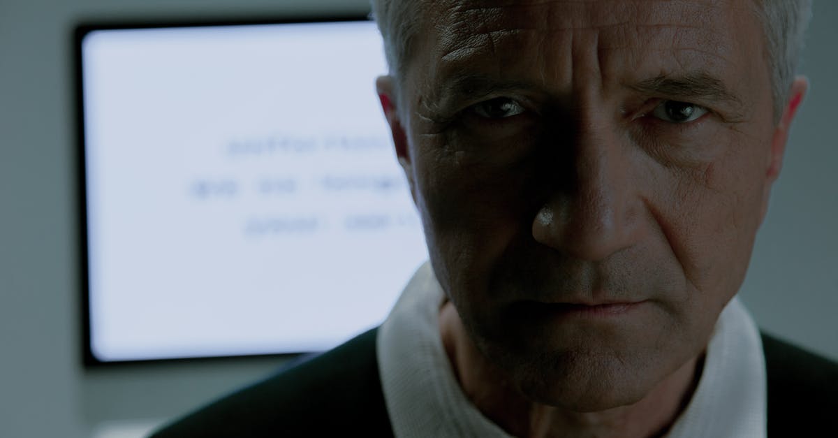 Useless upgrades? - Elderly man looking at camera and behind him screen saying that he is no more needed Useless upgrades? - Elderly man looking at camera and behind him screen saying that he is no more needed