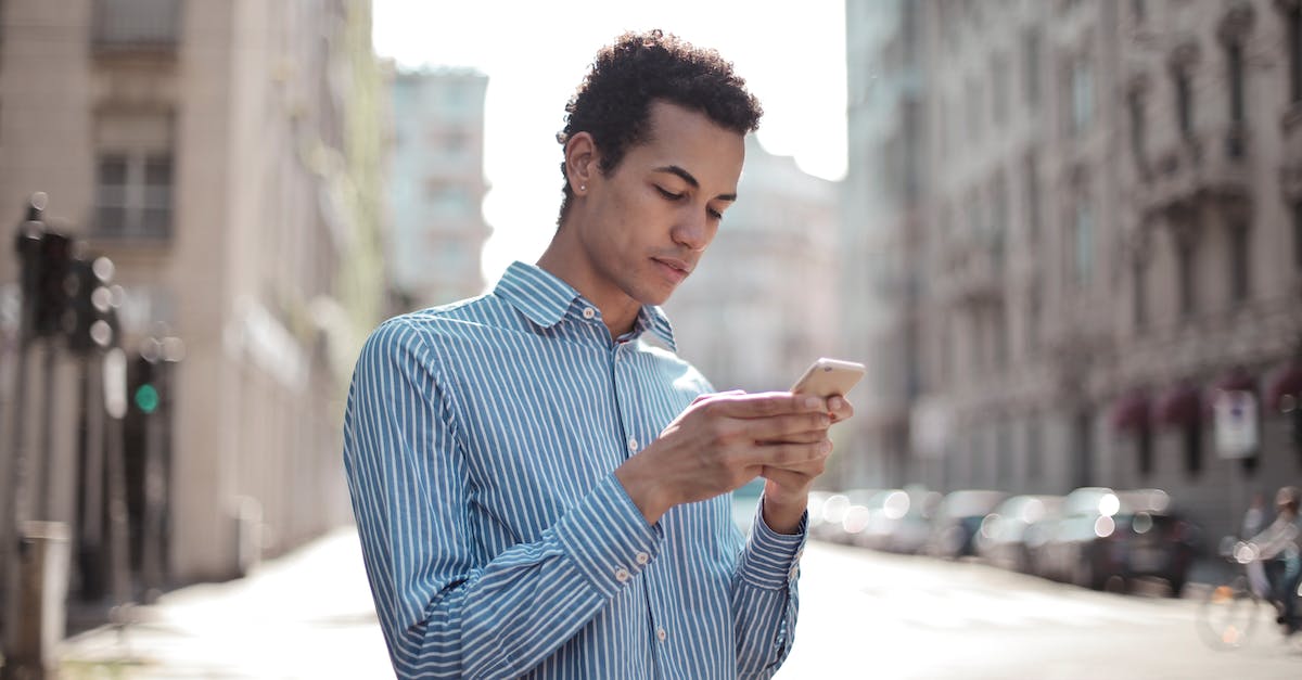 Using DirectX 11, getting message: Shader model 3.0 or better graphic device required - Concentrated ethnic guy surfing smartphone on street