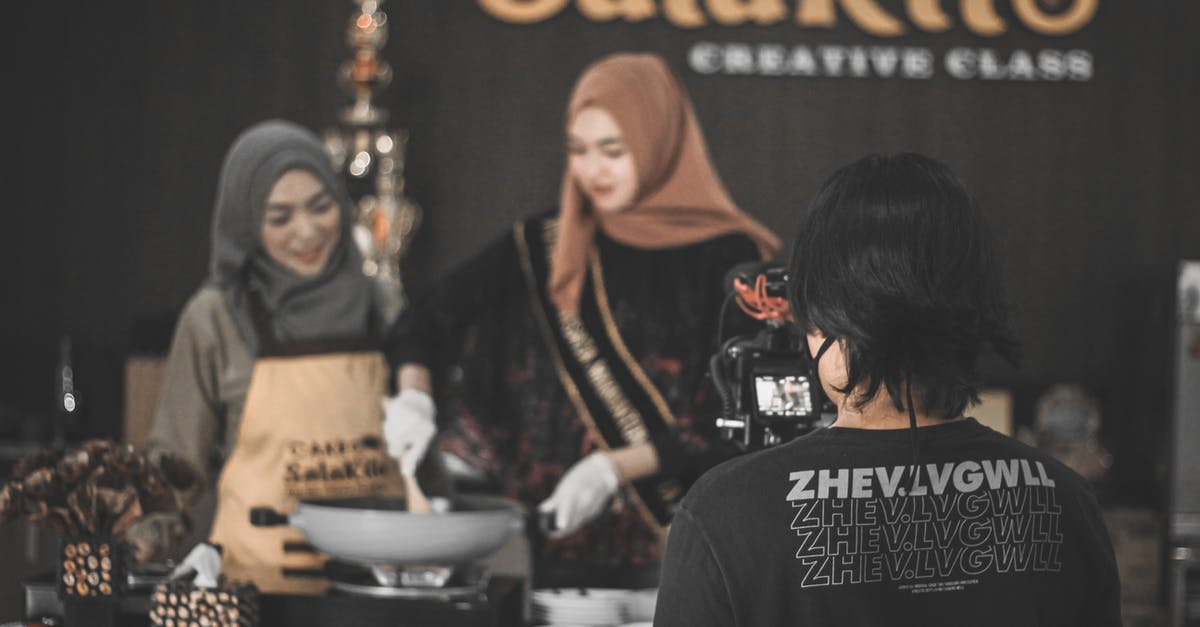 Using Enchantment nbt tag in json recipe - Back view of unrecognizable photographer shooting food vlog with ethnic women in hijabs cooking in modern kitchen Using Enchantment nbt tag in json recipe - Back view of unrecognizable photographer shooting food vlog with ethnic women in hijabs cooking in modern kitchen