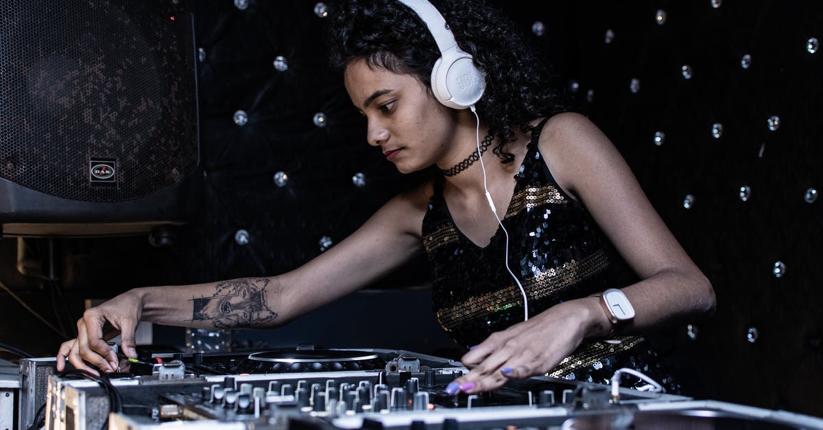Using GameCube discs on wii (controller) - Focused ethnic female DJ playing music at nightclub