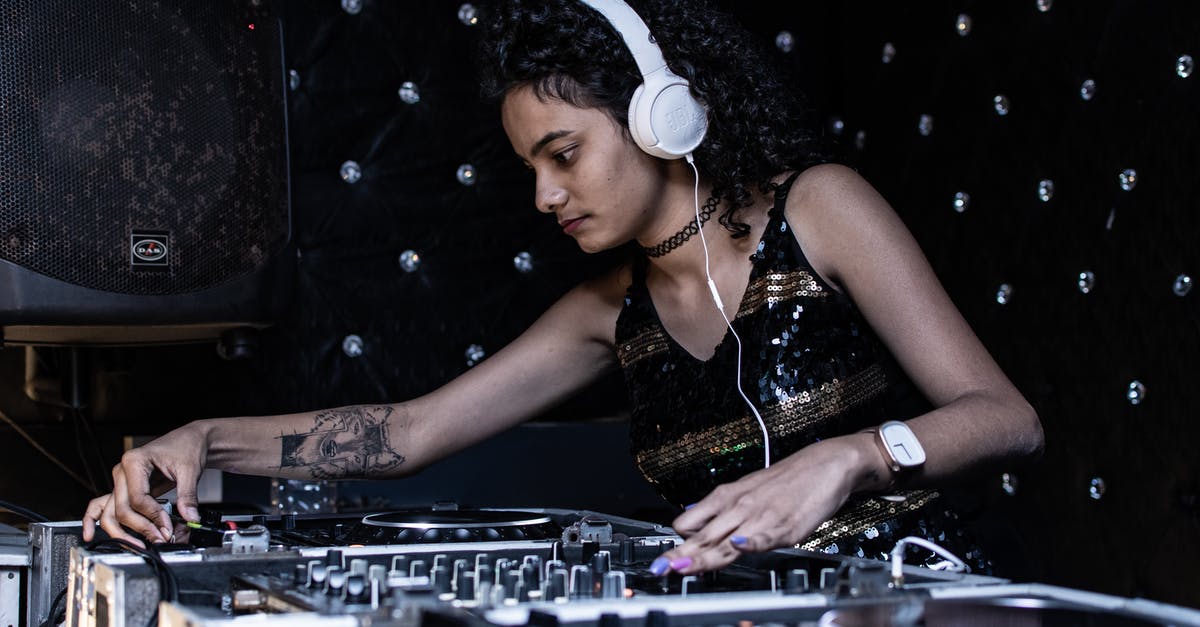 Using GameCube discs on wii (controller) - Focused ethnic female DJ playing music at nightclub Using GameCube discs on wii (controller) - Focused ethnic female DJ playing music at nightclub