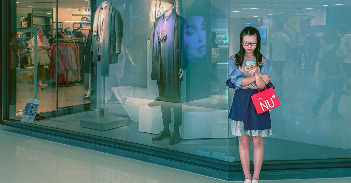 Using Gems to Buy More Loot for Upgrades Even Though The Storages are Full? - Focused young Asian woman surfing smartphone in shopping mall Using Gems to Buy More Loot for Upgrades Even Though The Storages are Full? - Focused young Asian woman surfing smartphone in shopping mall