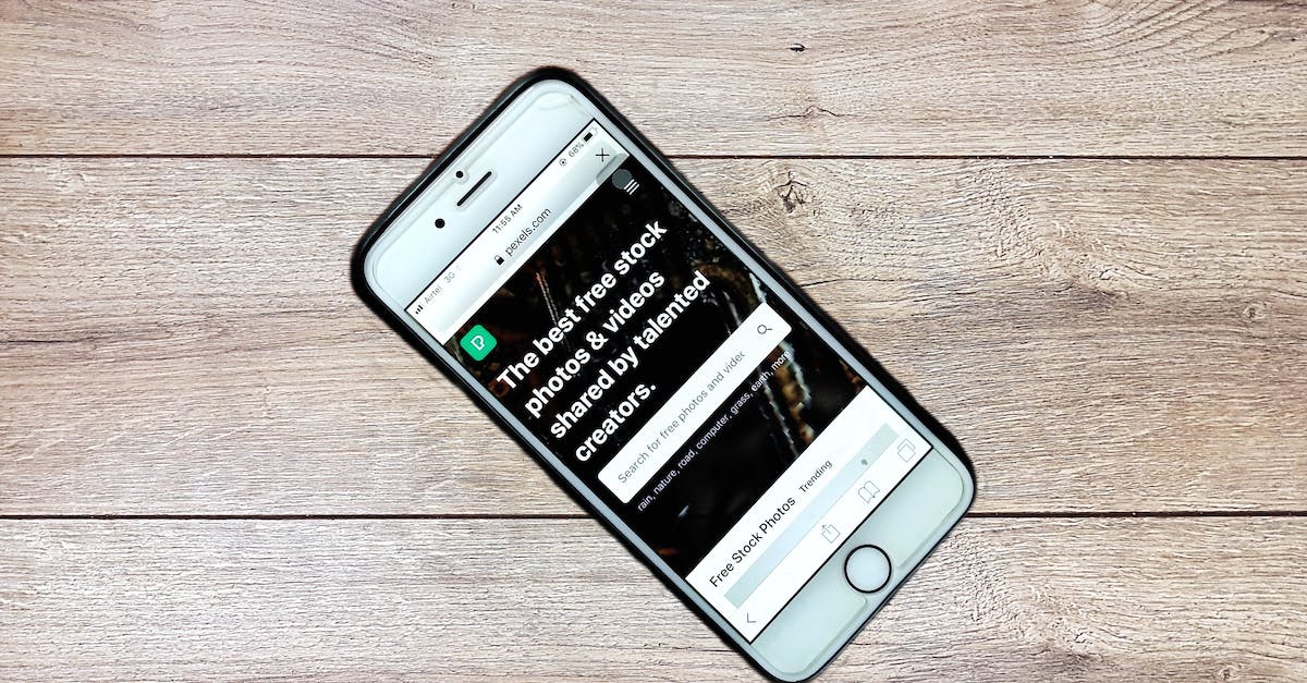 Using Portal Keys from Capsule - Top view contemporary mobile phone with opened website on screen placed on wooden table