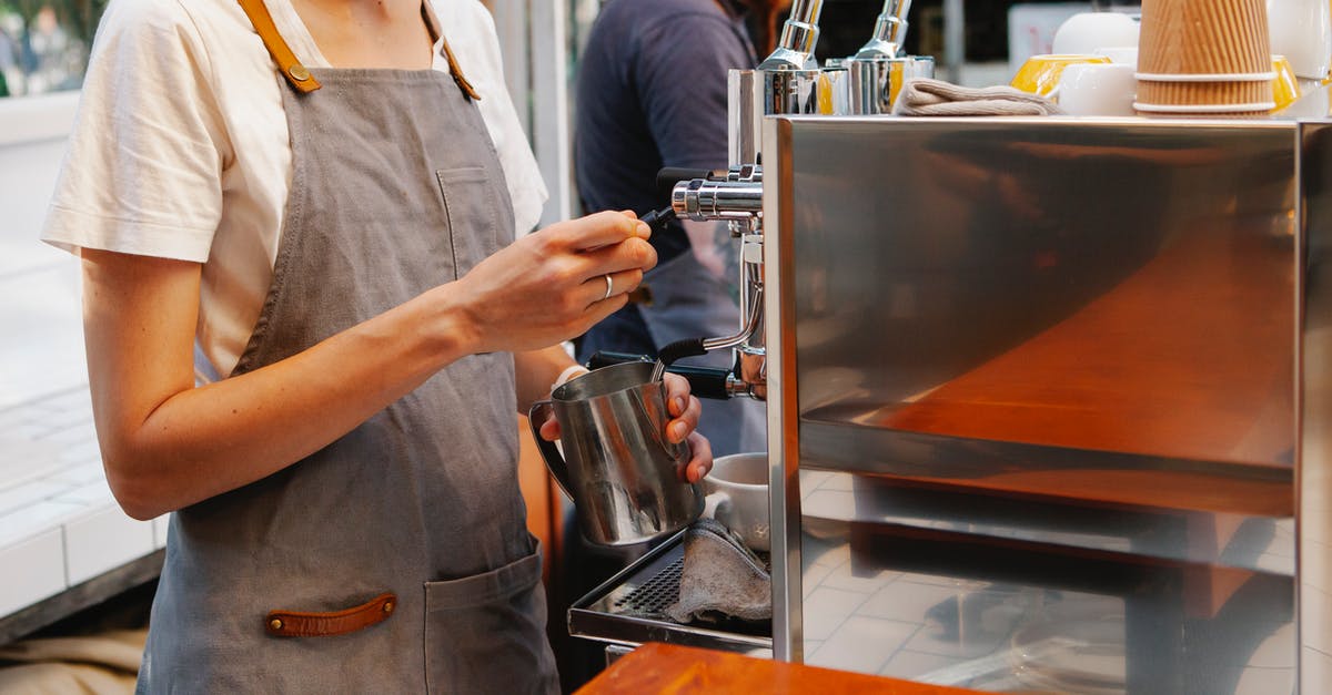 Using Radio to find higher SPECIAL dwellers - Crop anonymous female in apron making hot coffee with special coffee machine in kitchen of cafe Using Radio to find higher SPECIAL dwellers - Crop anonymous female in apron making hot coffee with special coffee machine in kitchen of cafe
