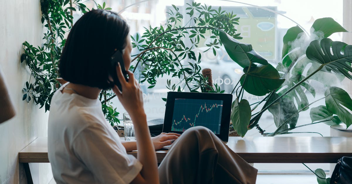 Using same account in two phones - Businesswoman in White Shirt Sitting on Chair while Having Phone Call