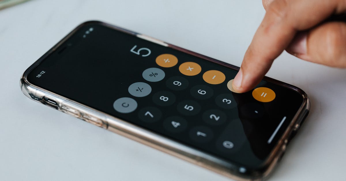 Using same account in two phones - Crop anonymous economist using calculator app on smartphone at work