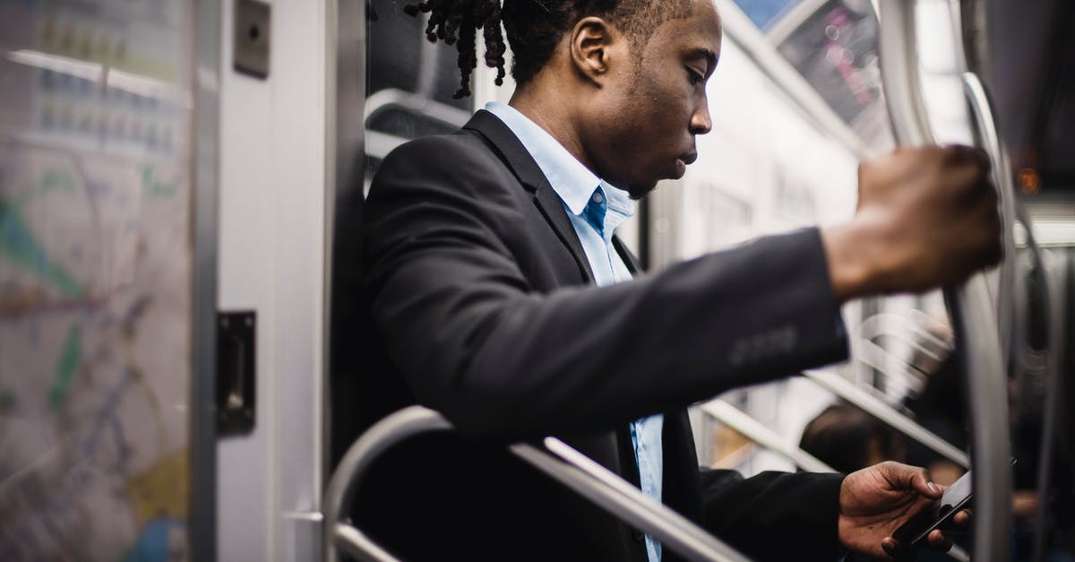 Using the map after update [duplicate] - Side view of crop wistful African American passenger with pigtails in formal wear using social media on cellphone while commuting to work on subway