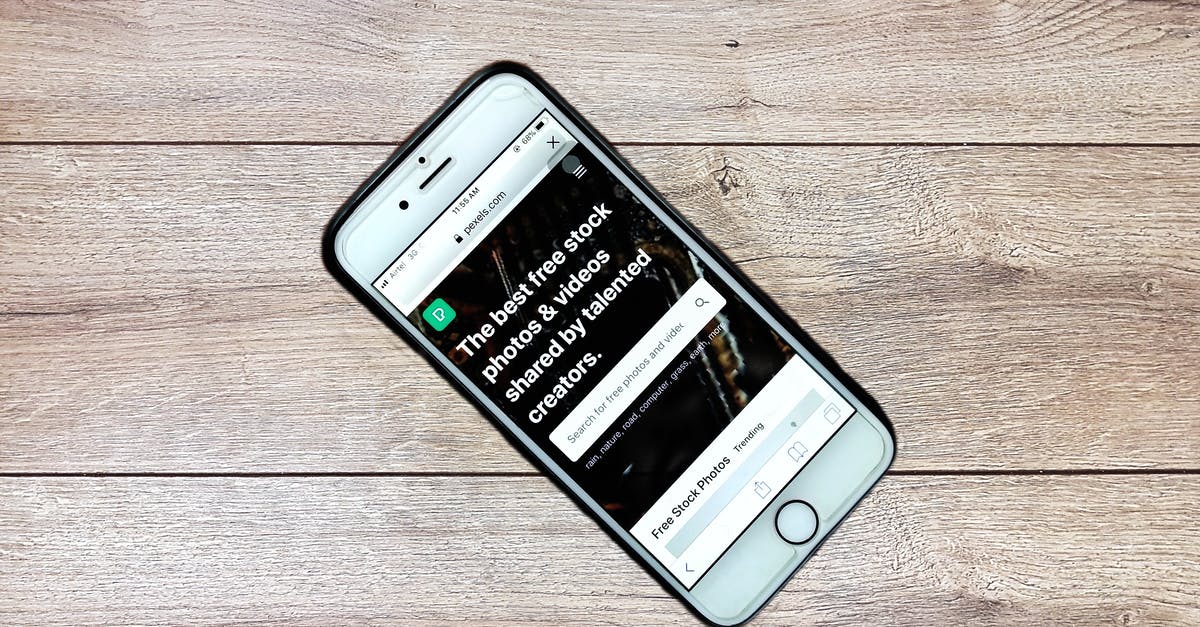 Using the same player when I connect to a local phone server from a different device? - Top view contemporary mobile phone with opened website on screen placed on wooden table