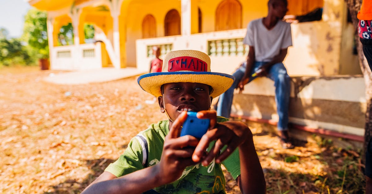 Using the same player when I connect to a local phone server from a different device? - Focused black male teenager browsing smartphone in countryside