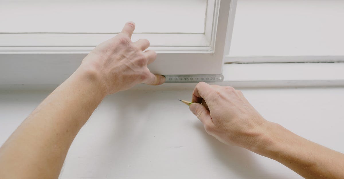 Using transparency in Minecraft. How? [duplicate] - From above of crop unrecognizable male worker measuring window frame with metal ruler and pencil in house