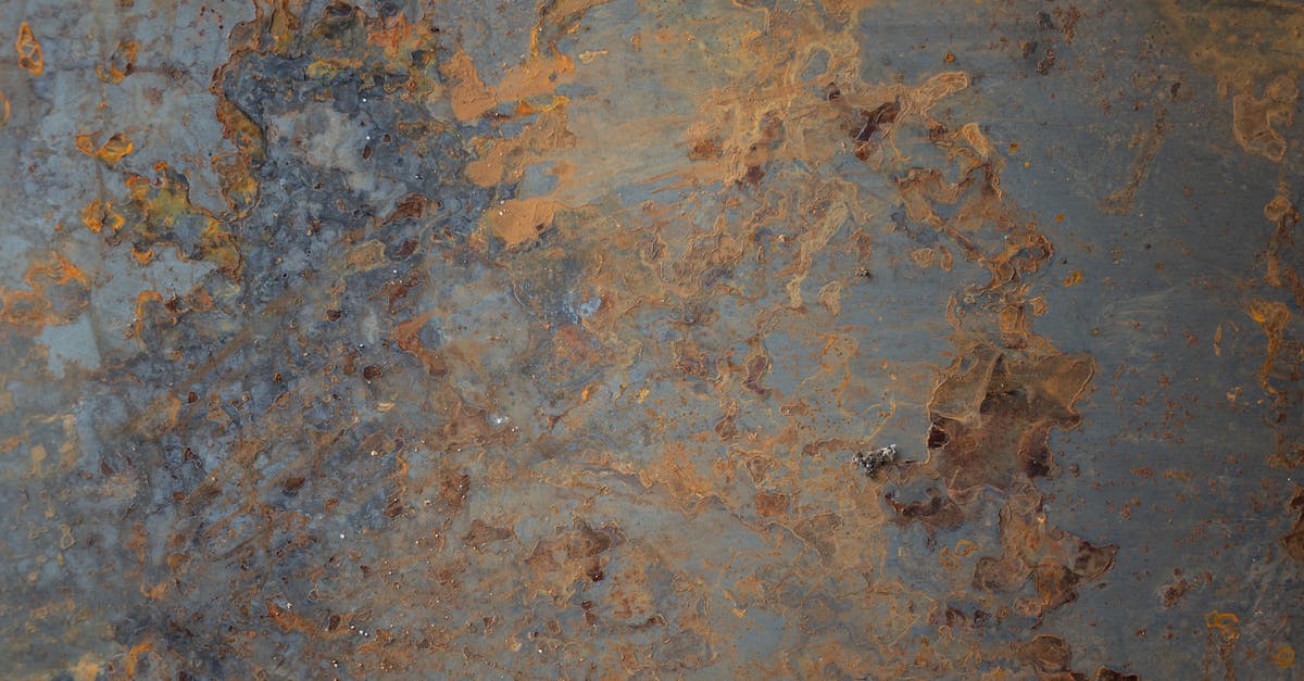 VERY confused about elemental damage - Textured background of aged shabby blue wall with light brown paint and cracks on surface