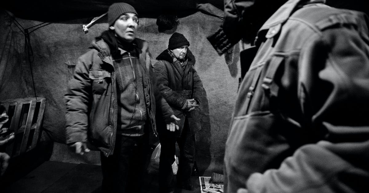 Very detailed Tellraw command that i need help with [duplicate] - Black and white of men in outerwear in shelter for homeless people in poverty