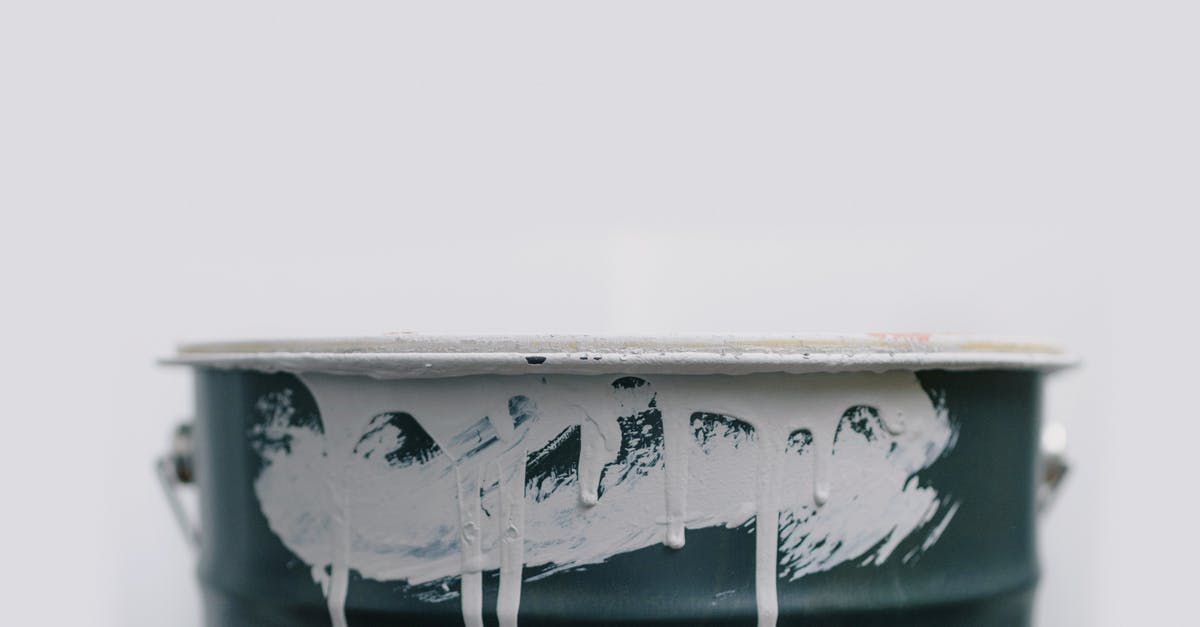 Visual glitch in FTB Revelation with SEUS Renewal shaders [closed] - Closeup of white drips from paint on green metal bucket during repair at home