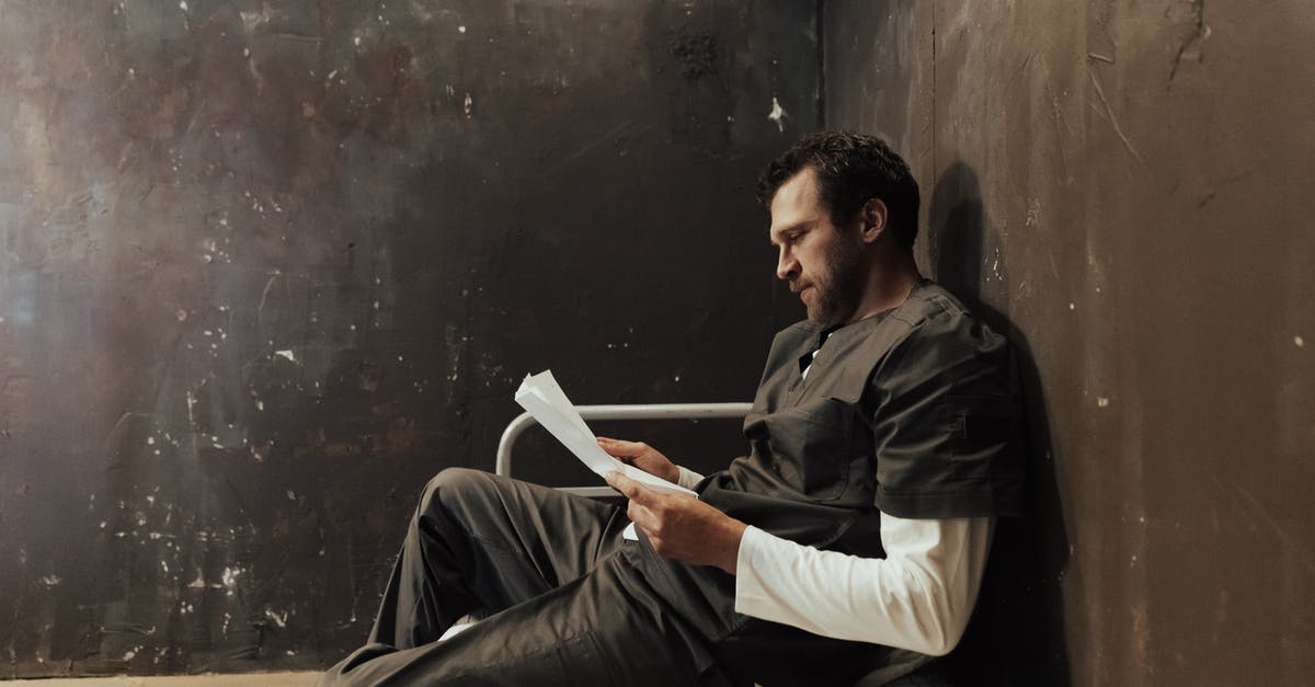 Wailing Prison escape! - Man Siting on Bed Reading a Paper Wailing Prison escape! - Man Siting on Bed Reading a Paper