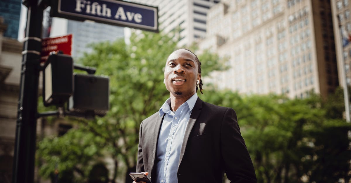 Warmongering though proxy in Civ 5 - From below of young handsome black male in smart suit listening to music and waiting for car to pass while standing near street sign in Manhattan on sunny day Warmongering though proxy in Civ 5 - From below of young handsome black male in smart suit listening to music and waiting for car to pass while standing near street sign in Manhattan on sunny day