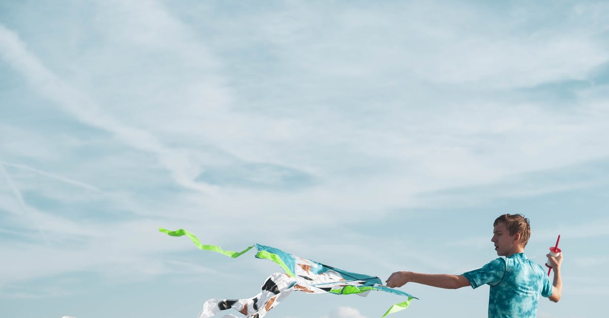 Was blowing air to N64 Game Pack ever recommended? - Teenager with waving kite against sky Was blowing air to N64 Game Pack ever recommended? - Teenager with waving kite against sky
