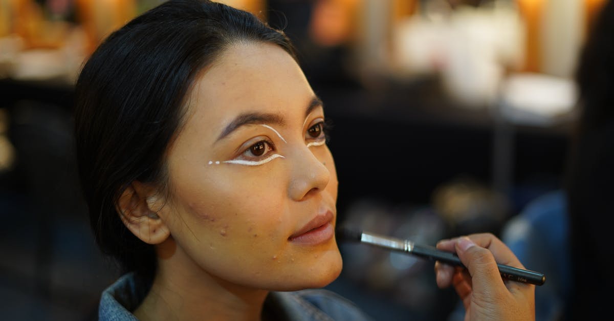 Ways to apply bleed effect? - Crop visagiste applying makeup on face of woman Ways to apply bleed effect? - Crop visagiste applying makeup on face of woman