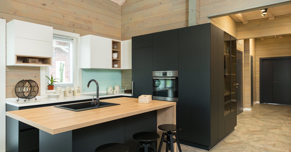 What's the advantage of a pre-built stove/fire/barrel? - Minimalist style of kitchen with bar chairs at counter and matte cupboards in spacious private house What's the advantage of a pre-built stove/fire/barrel? - Minimalist style of kitchen with bar chairs at counter and matte cupboards in spacious private house