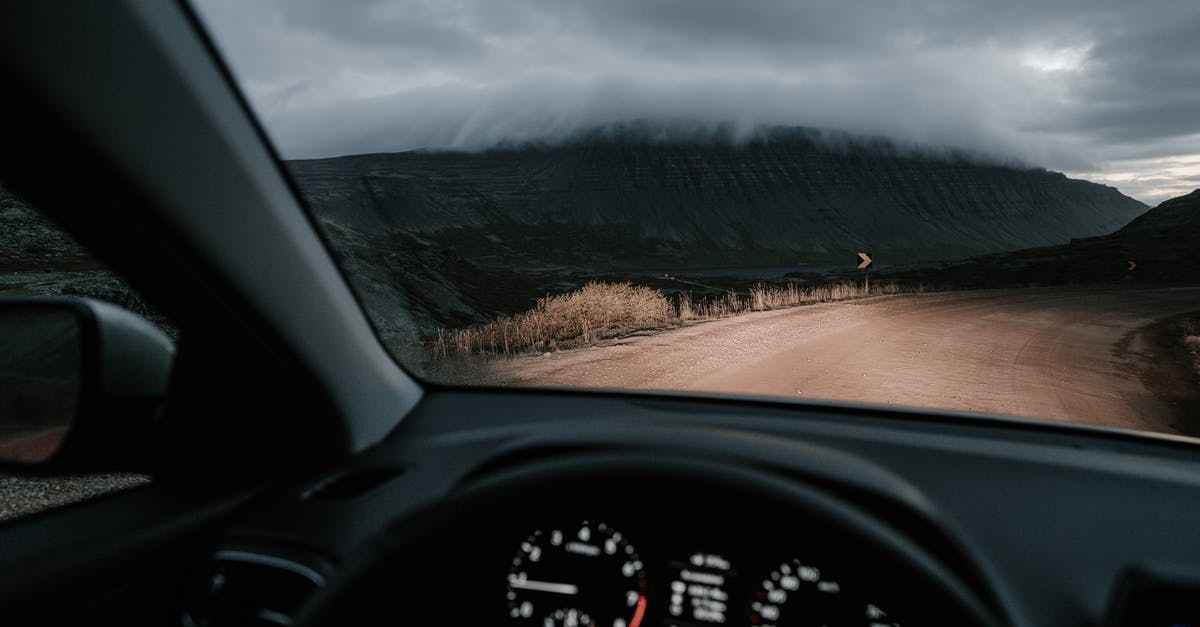 What's the best route to all targets on R&D side mission? - View from inside car on road in countryside near mounts and faded grass in mist under cloudy sky