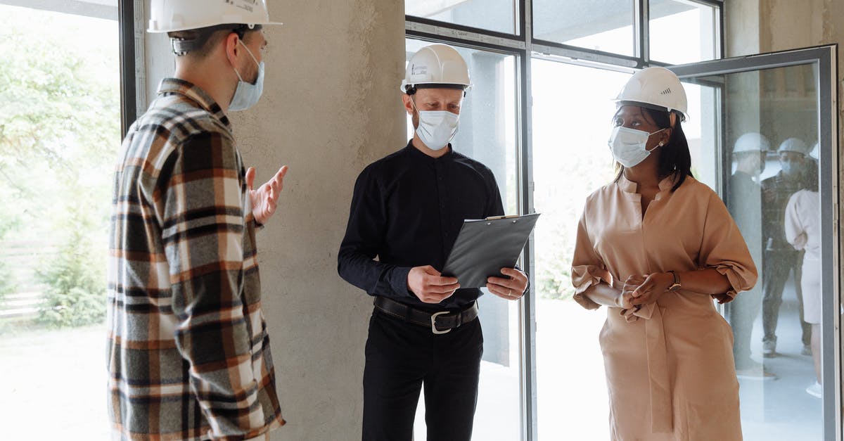 What's the deal with the saarthal door [duplicate] - A Group of People Wearing Face Mask and Hard Hats while Having Conversation